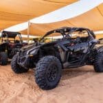 Can-Am Maverick X3 dune buggy racing across Dubai’s desert dunes