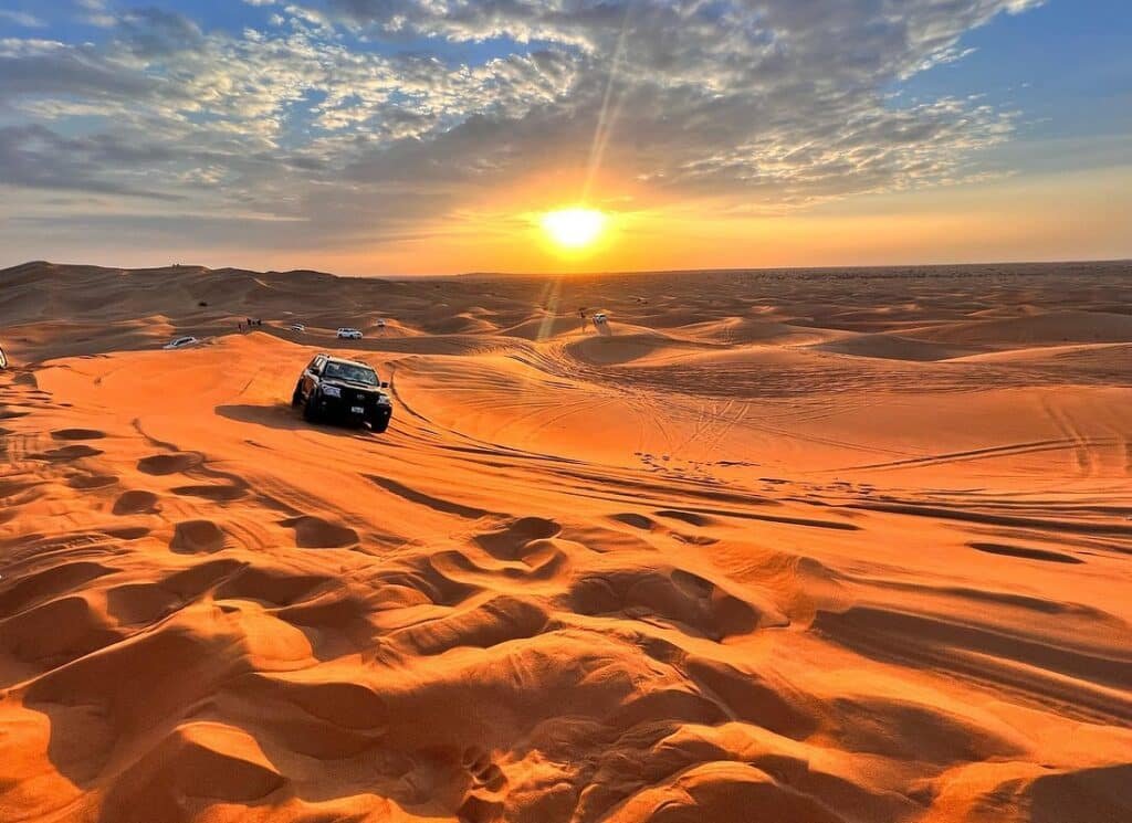 Desert sunset with off-road vehicle
