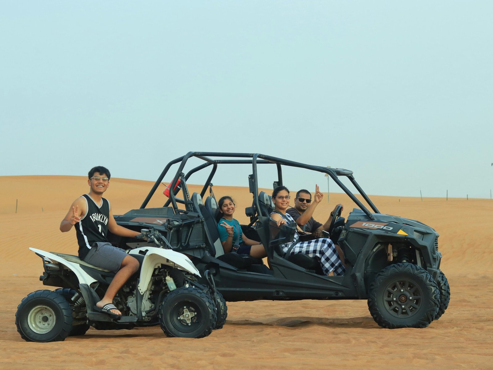 Driving a dune buggy over giant sand dunes in Dubai