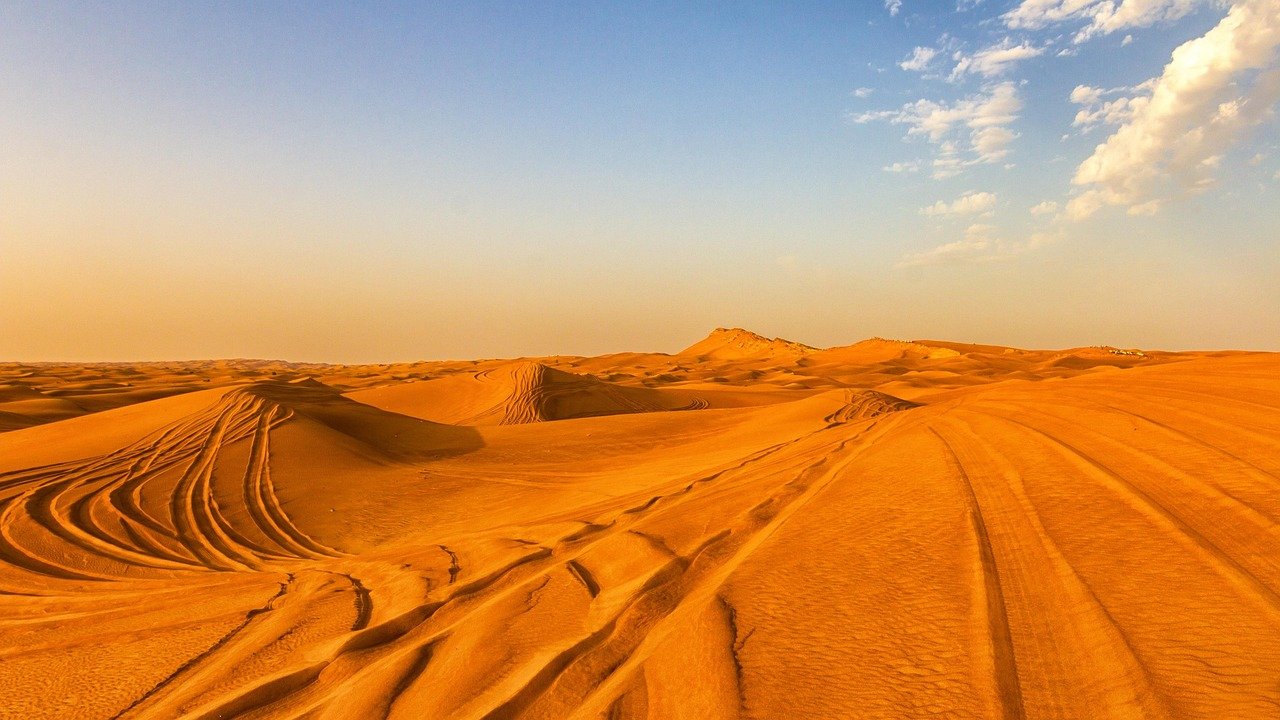 Red sand dunes and desert scenery during dune buggy Dubai ride