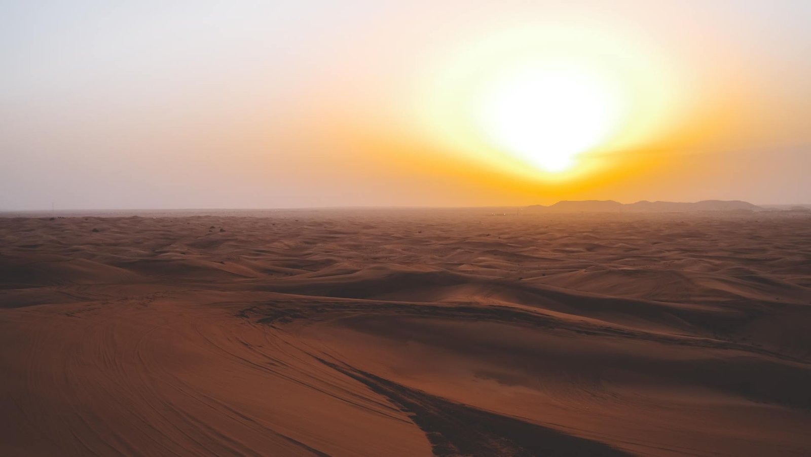 Evening Dune Buggy Dubai ride during sunset with golden sky and desert dunes