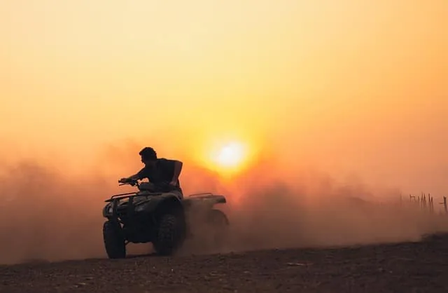 Dune buggy riding at sunset in Dubai desert