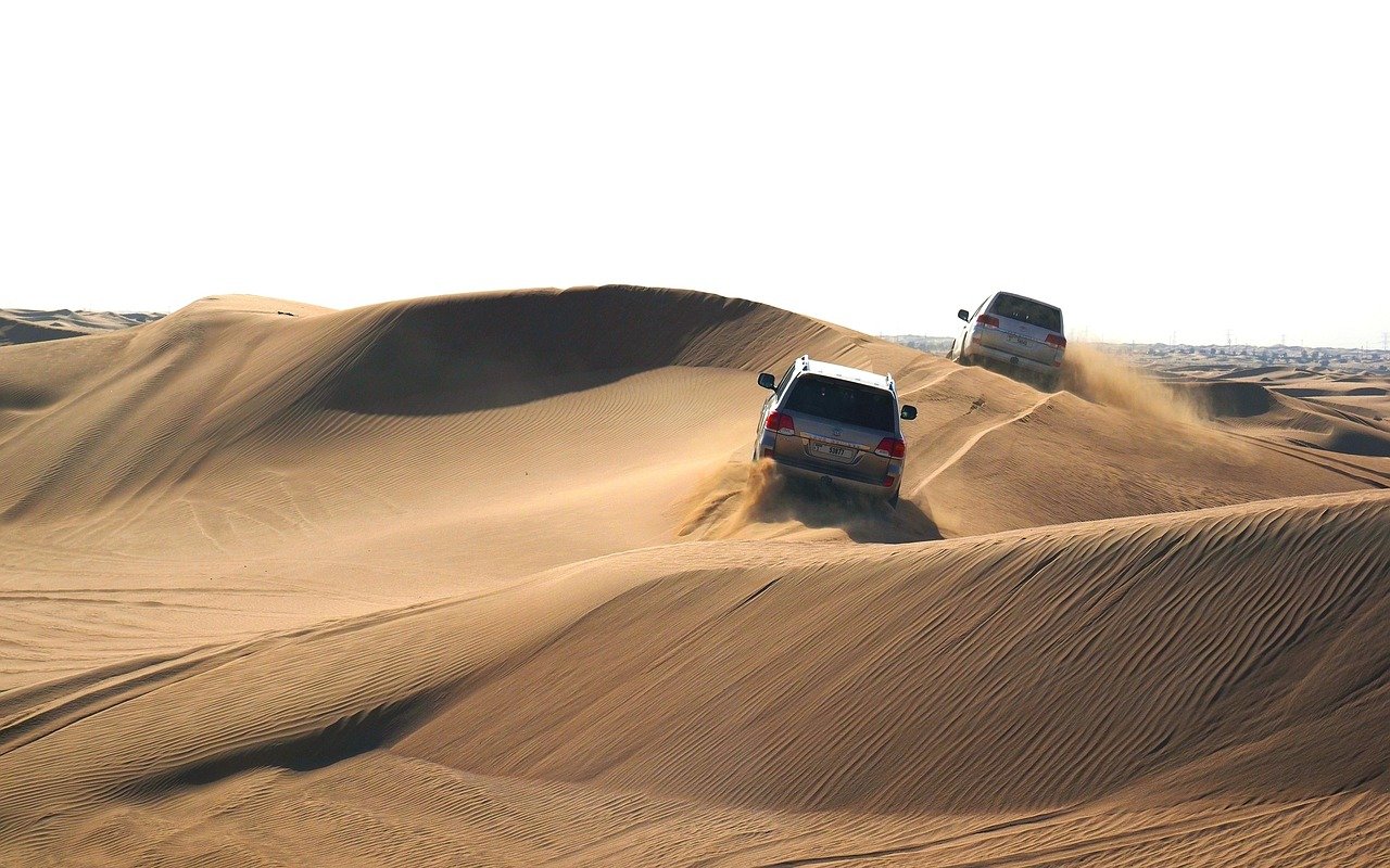 Dune buggy Dubai riding across red desert dunes